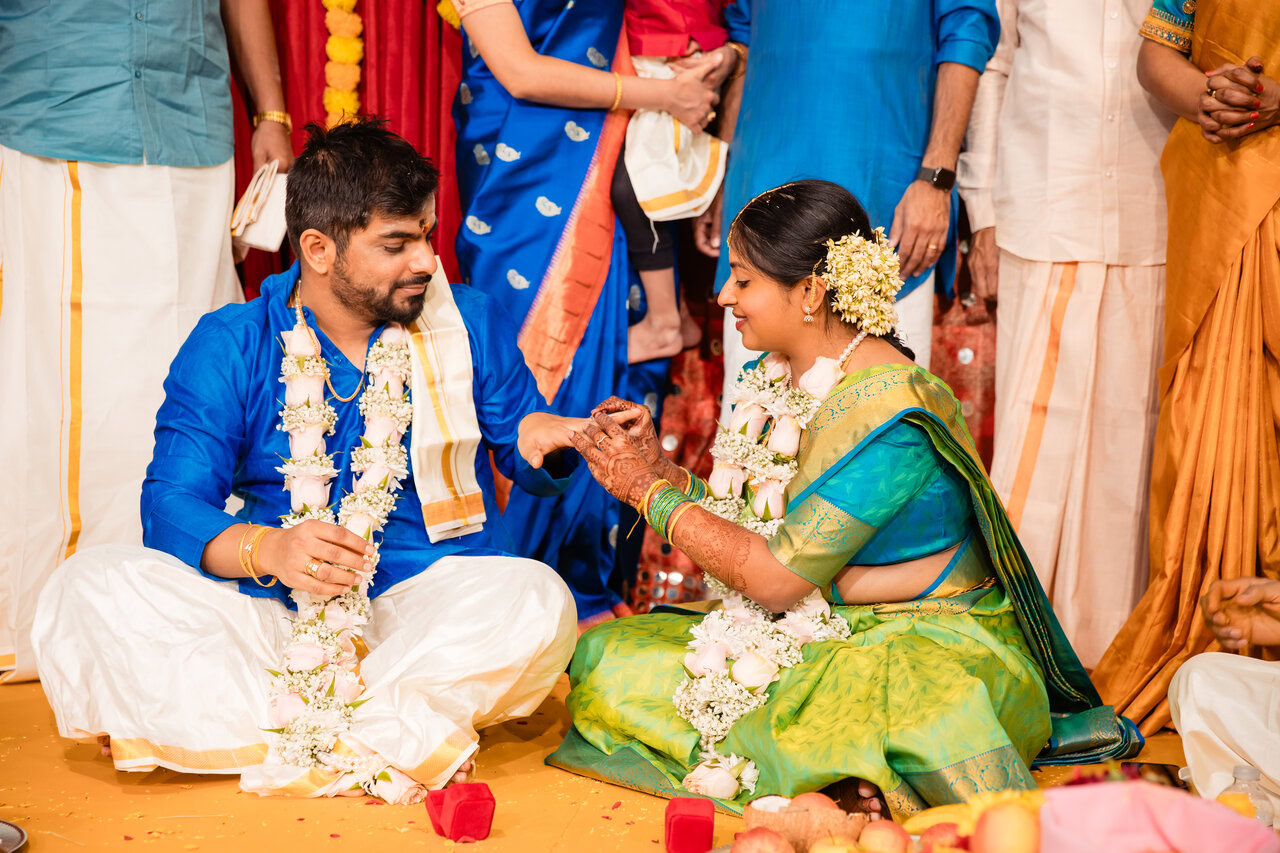Traditional Indian wedding ceremony with participants in colorful attire performing sacred rituals