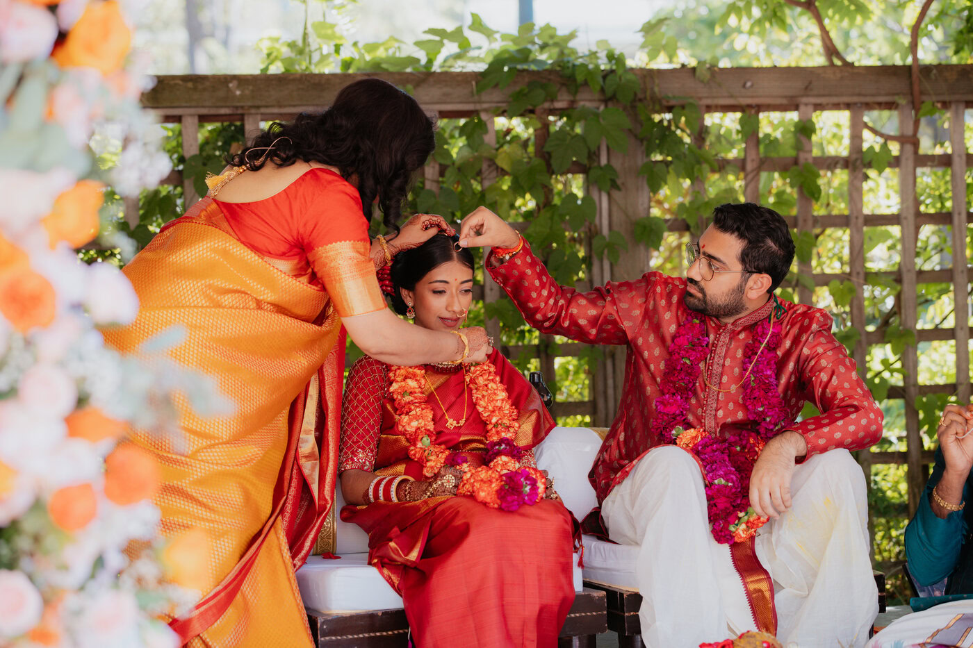 Traditional Indian wedding ceremony with participants in colorful attire performing sacred rituals