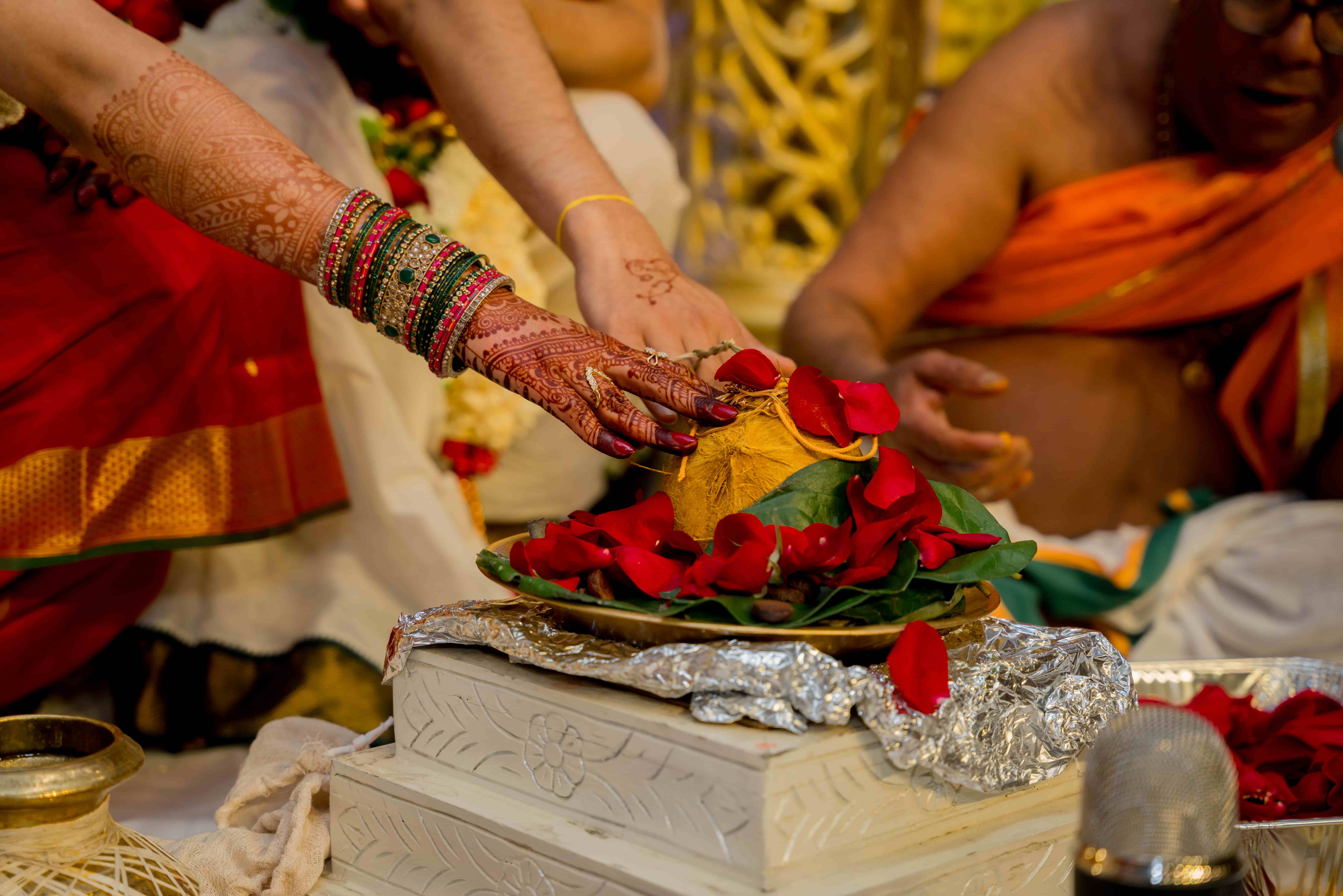 Traditional Indian wedding ceremony with participants in colorful attire performing sacred rituals